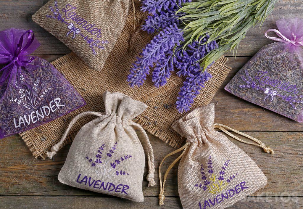 Mit Lavendel bedruckte und mit Trockenblumen gefüllte Organza-, Jute- und Leinensäckchen.