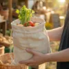 Leinensack mit Gemüse und Kräutern in den Händen gehalten im Bio-Laden